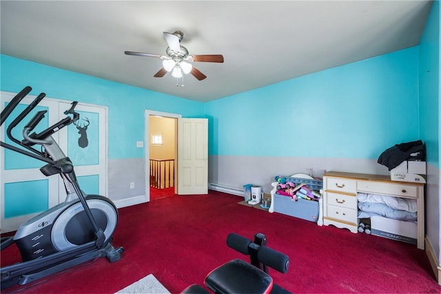 workout area featuring dark colored carpet, ceiling fan, and a baseboard radiator