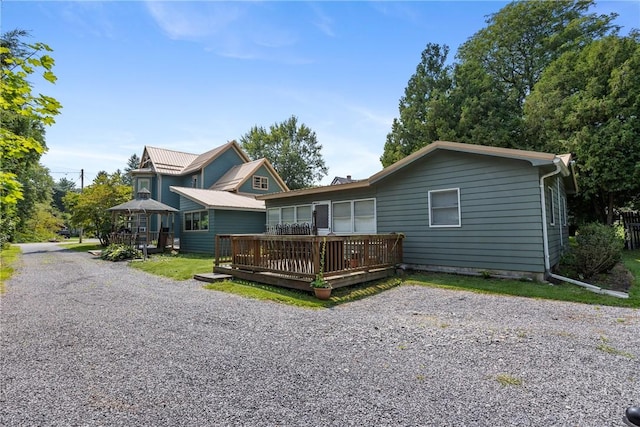 view of front of house featuring a wooden deck and a gazebo