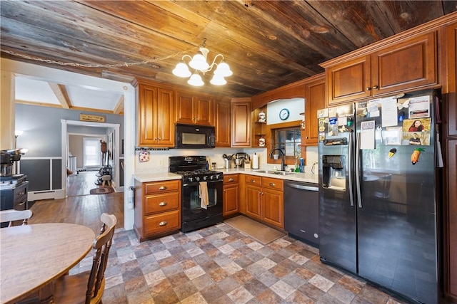 kitchen featuring sink, baseboard heating, an inviting chandelier, black appliances, and wooden ceiling