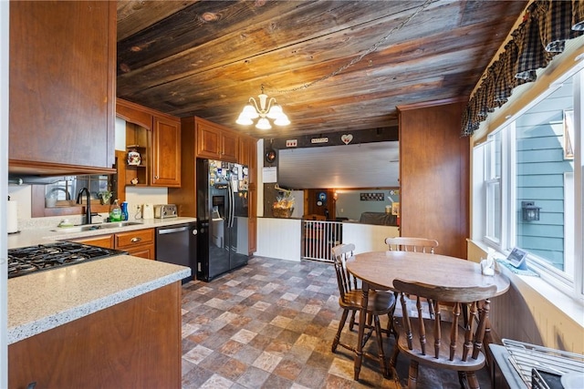 kitchen featuring sink, black fridge, wood ceiling, stainless steel dishwasher, and pendant lighting