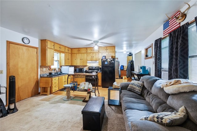 living room with light carpet and ceiling fan