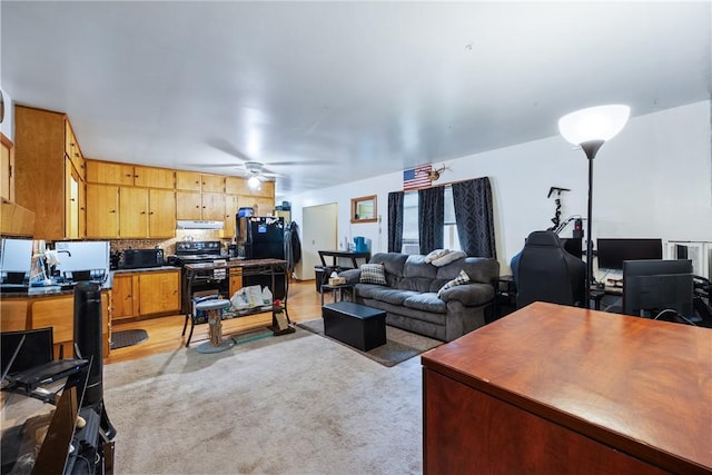 carpeted living room with ceiling fan