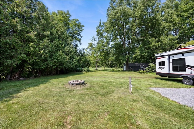 view of yard featuring an outdoor fire pit