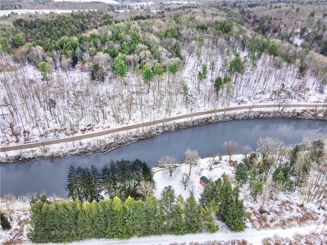 snowy aerial view featuring a water view