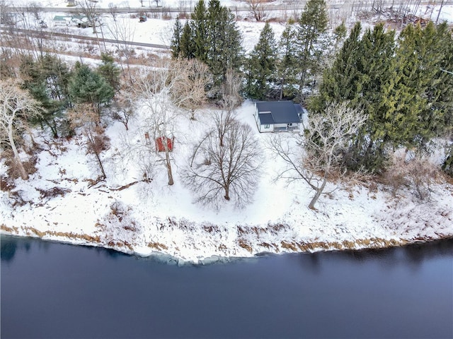 snowy aerial view with a water view