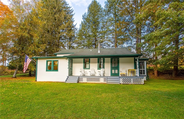 view of front of home featuring a porch, a sunroom, and a front lawn