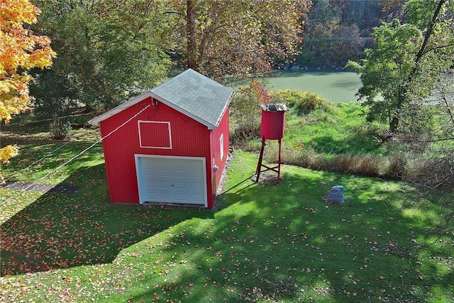 view of outdoor structure with a garage and a yard