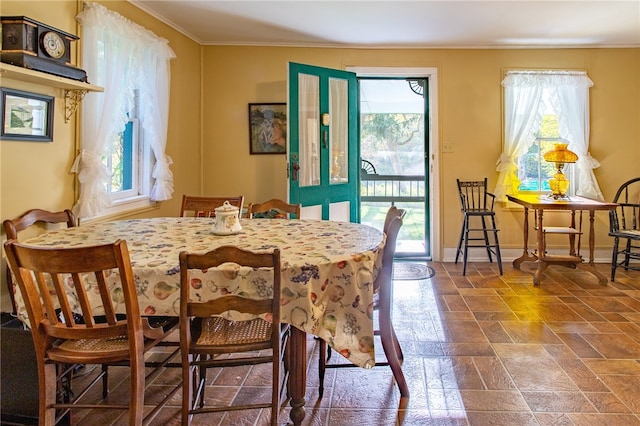 dining space with crown molding