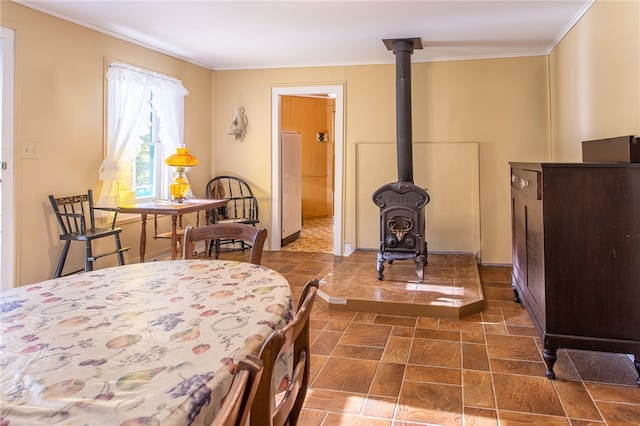 bedroom with ornamental molding and a wood stove