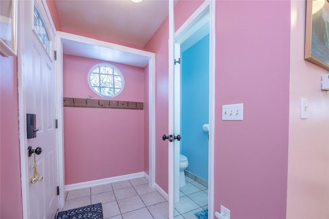 doorway to outside with light tile patterned floors