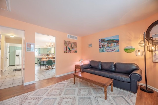 living room with hardwood / wood-style flooring and a chandelier