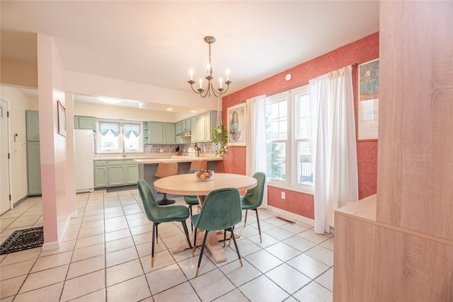 dining area featuring an inviting chandelier, a healthy amount of sunlight, and light tile patterned flooring