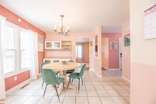 dining room featuring light tile patterned floors and a chandelier