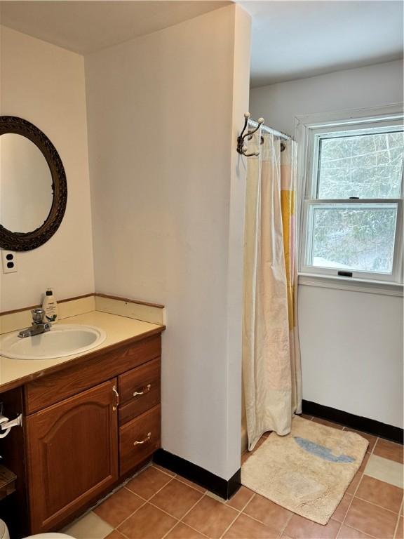 bathroom with tile patterned floors, vanity, and a shower with shower curtain