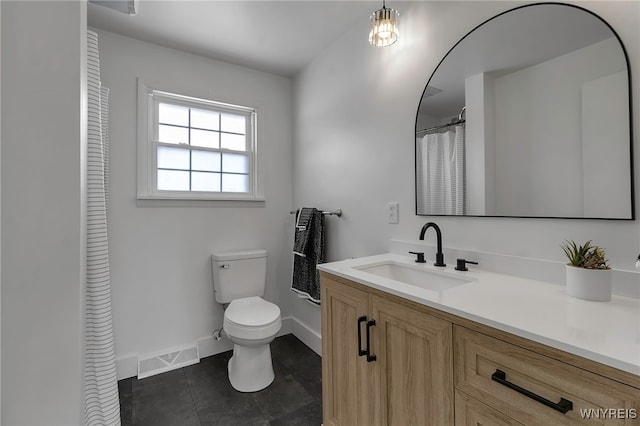 bathroom with vanity, tile patterned floors, and toilet