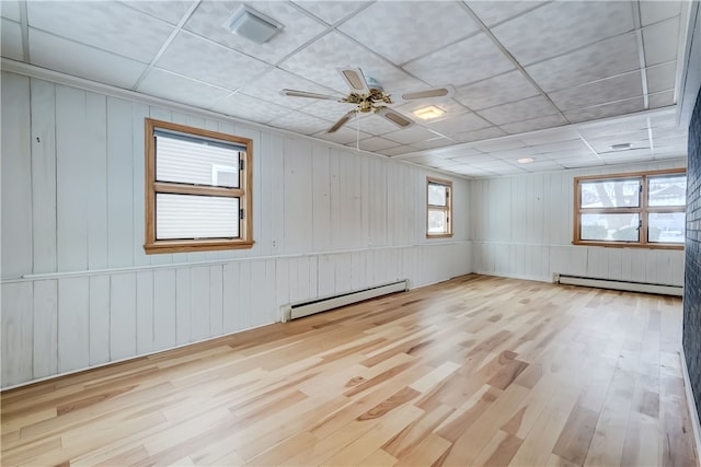 unfurnished room featuring ceiling fan, a baseboard radiator, and light hardwood / wood-style flooring