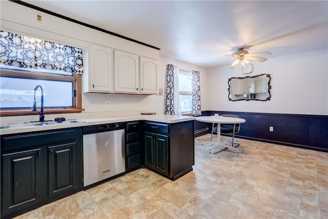 kitchen with sink, dishwasher, kitchen peninsula, ceiling fan, and white cabinets