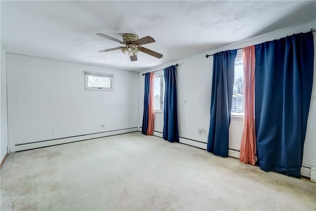 carpeted empty room with ceiling fan and baseboard heating