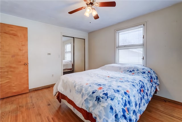 bedroom featuring hardwood / wood-style flooring, a closet, and ceiling fan