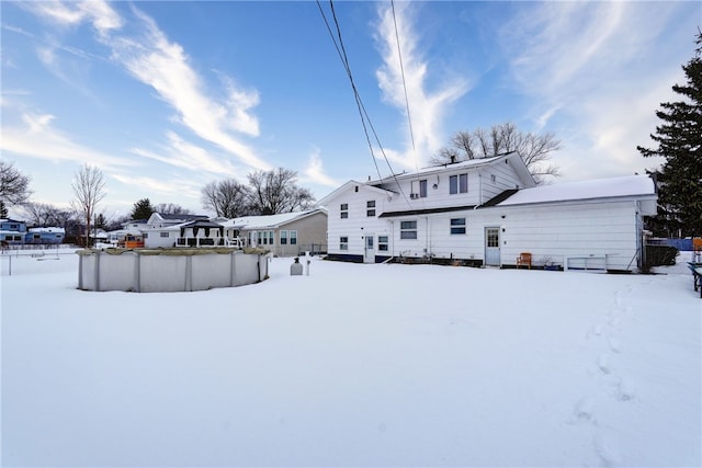 snow covered house with a covered pool