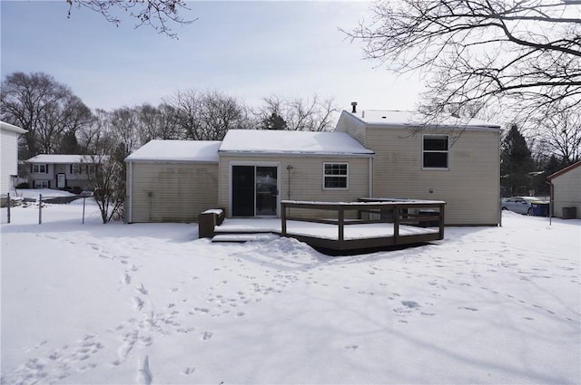 view of snow covered rear of property