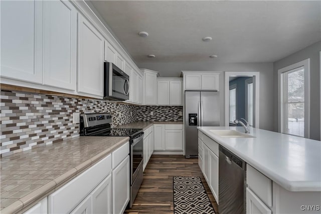 kitchen featuring white cabinetry, appliances with stainless steel finishes, dark hardwood / wood-style floors, and sink