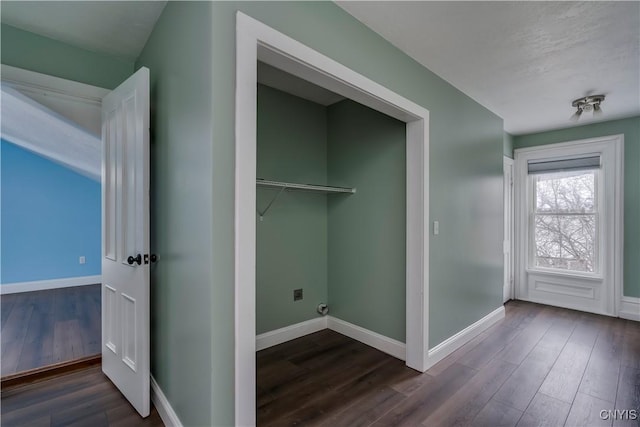 laundry room featuring dark wood-type flooring