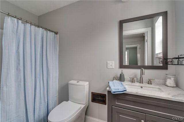 bathroom featuring vanity, toilet, and a shower with shower curtain