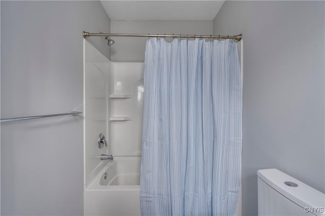 bathroom with shower / tub combo with curtain and toilet