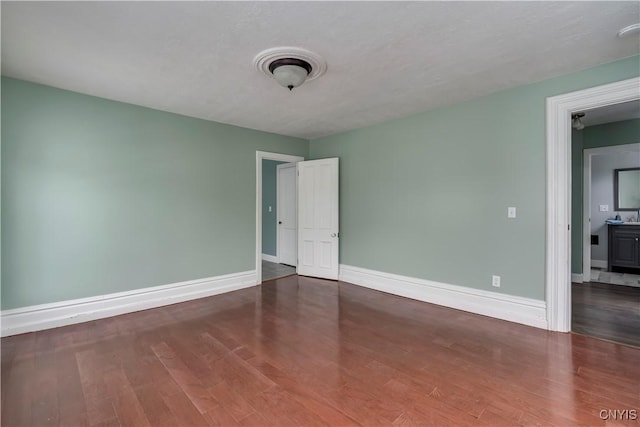 unfurnished room with hardwood / wood-style floors