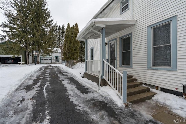 snow covered property featuring a garage