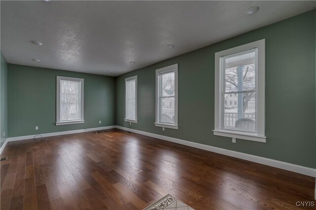 unfurnished room featuring dark hardwood / wood-style flooring