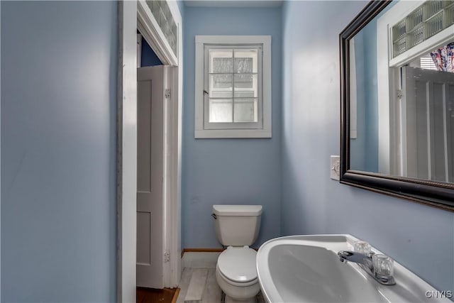 bathroom with toilet, sink, and hardwood / wood-style floors