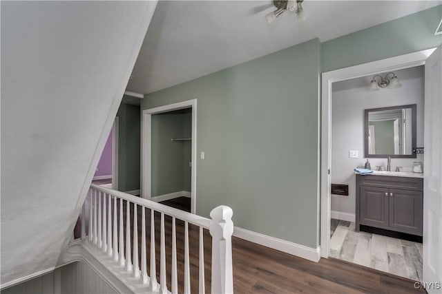 corridor with sink and dark hardwood / wood-style floors