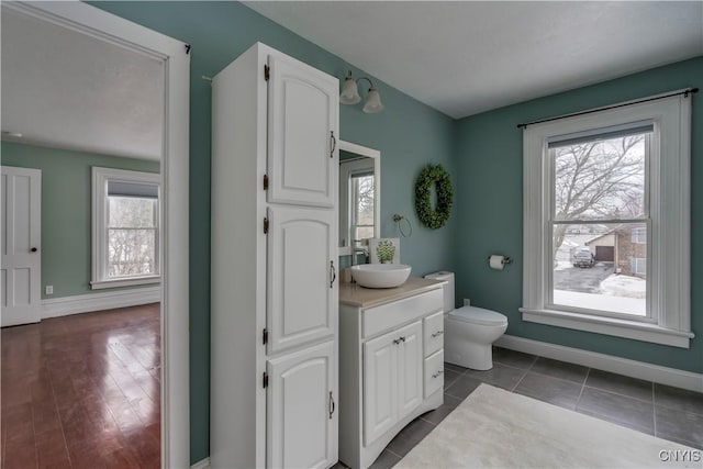 bathroom featuring tile patterned flooring, vanity, and toilet