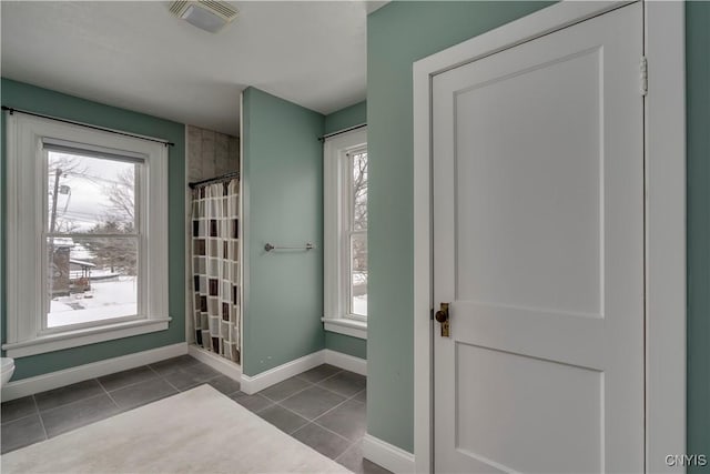 doorway to outside featuring dark tile patterned flooring