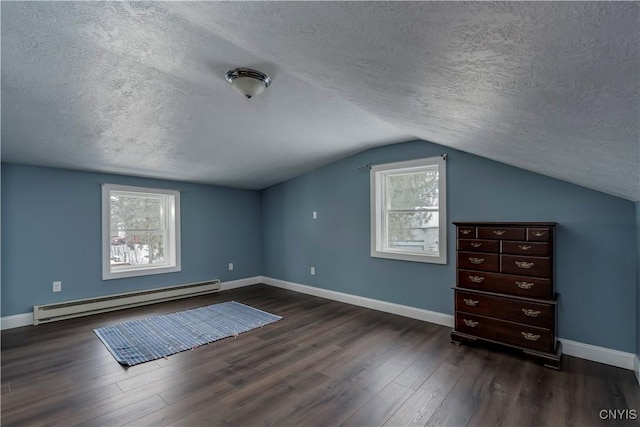 bonus room with lofted ceiling, a baseboard heating unit, dark wood-type flooring, and a textured ceiling