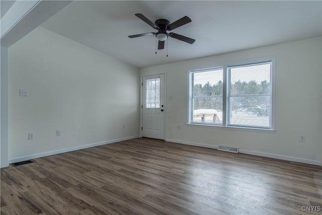 interior space with ceiling fan and dark hardwood / wood-style flooring