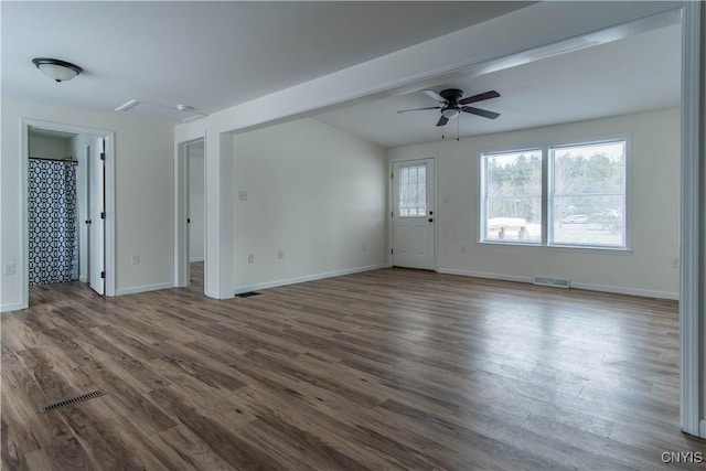 unfurnished living room with dark hardwood / wood-style flooring and ceiling fan