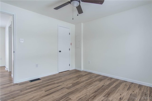 spare room with ceiling fan and light hardwood / wood-style flooring