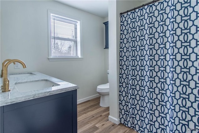 bathroom featuring walk in shower, vanity, toilet, and wood-type flooring