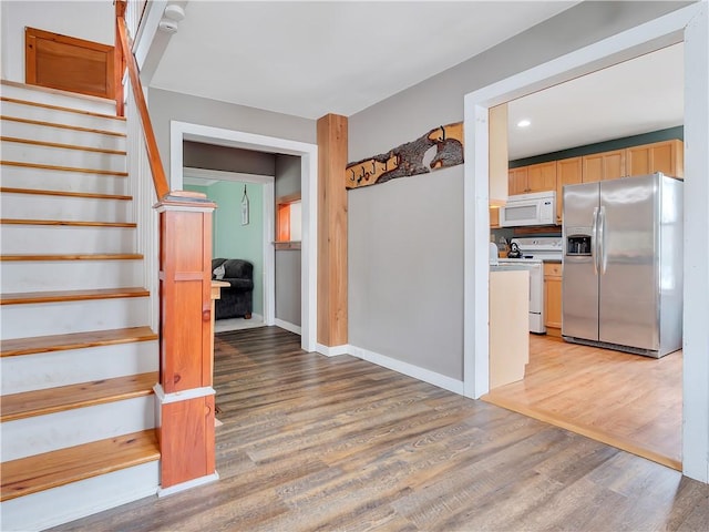 stairs featuring wood-type flooring