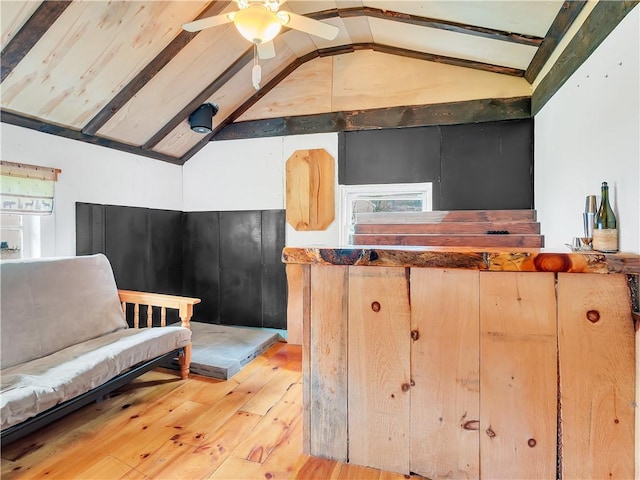 kitchen featuring vaulted ceiling with beams, light hardwood / wood-style floors, ceiling fan, and light brown cabinets