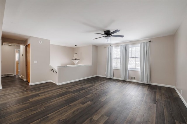 empty room featuring ceiling fan and dark hardwood / wood-style flooring