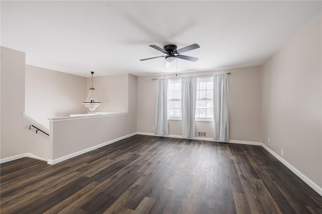 unfurnished room with dark wood-type flooring and ceiling fan