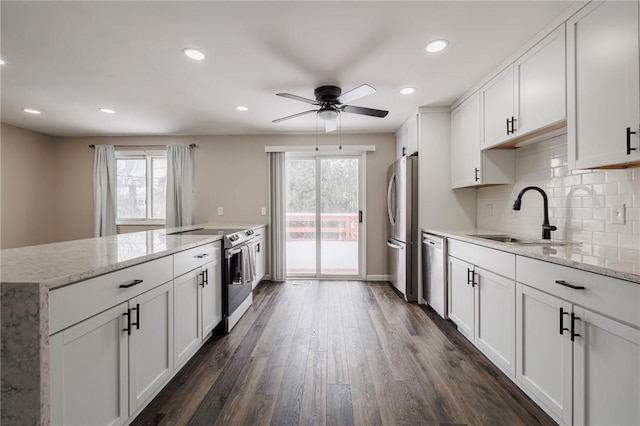 kitchen featuring stainless steel appliances, sink, and white cabinets