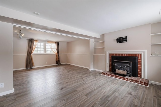 unfurnished living room with hardwood / wood-style floors and a fireplace