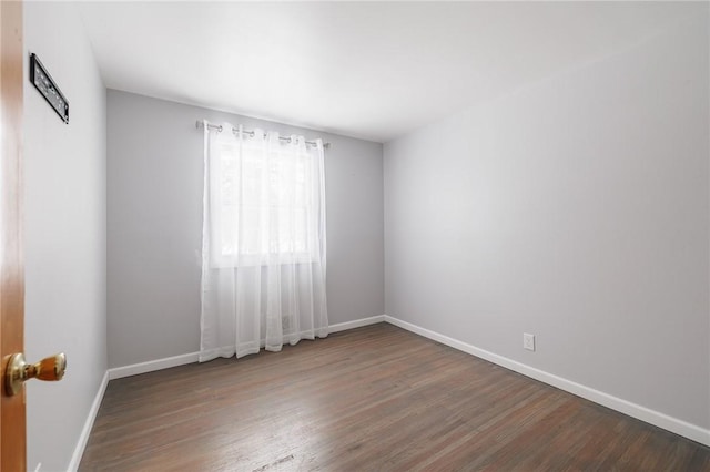 empty room with dark hardwood / wood-style floors