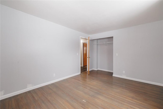 unfurnished bedroom with hardwood / wood-style flooring and a closet