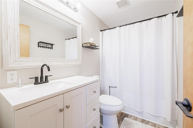 full bathroom with hardwood / wood-style flooring, vanity, toilet, and shower / bath combo